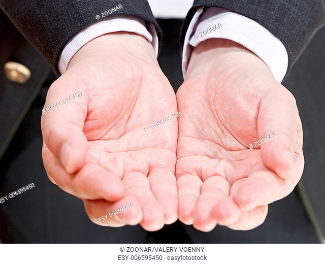 businessman holding empty handful from two palms