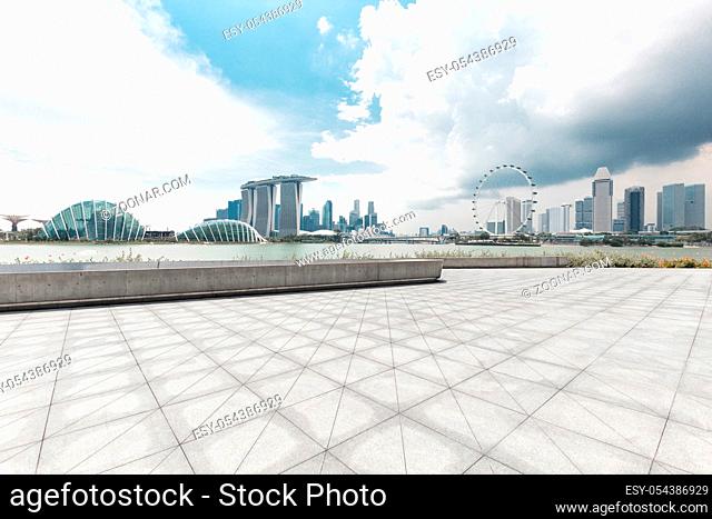 empty marble floor and cityscape of singapore in blue cloud sky