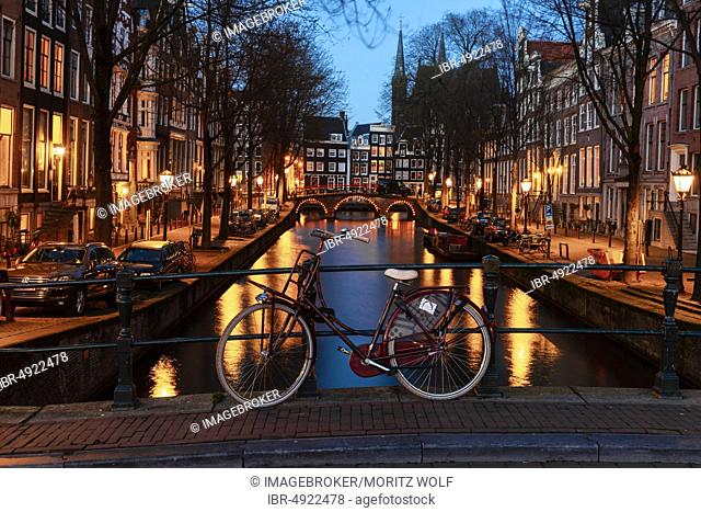 Evening atmosphere, bicycle on a bridge, Leidsegracht, canal with historic houses, Amsterdam, North Holland, Netherlands