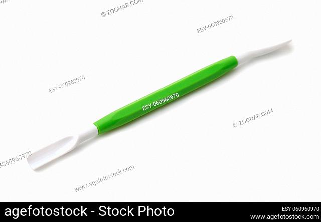 Green plastic double ended modelling tool isolated on white