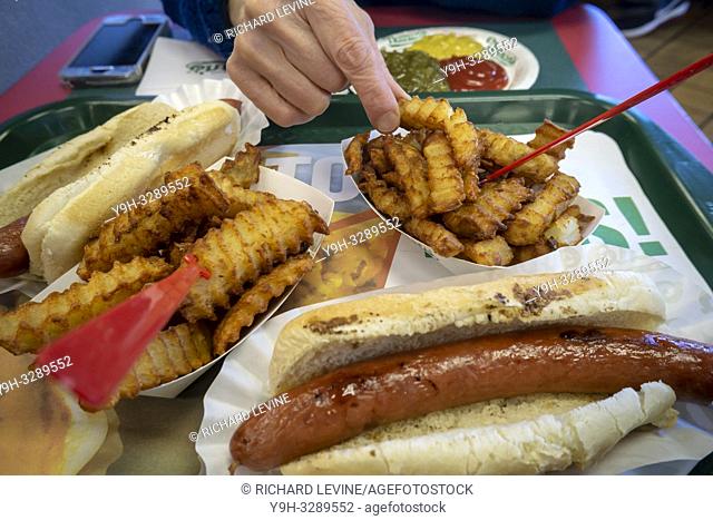 An order of hot dogs and fries in the stand-alone Nathan's Famous location in the Bay Ridge neighborhood of Brooklyn in New York on its last day, Sunday