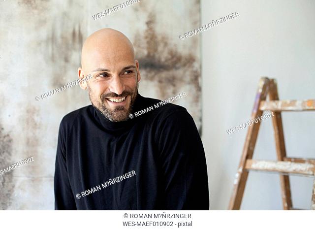 Portrait of smiling man wearing black turtleneck