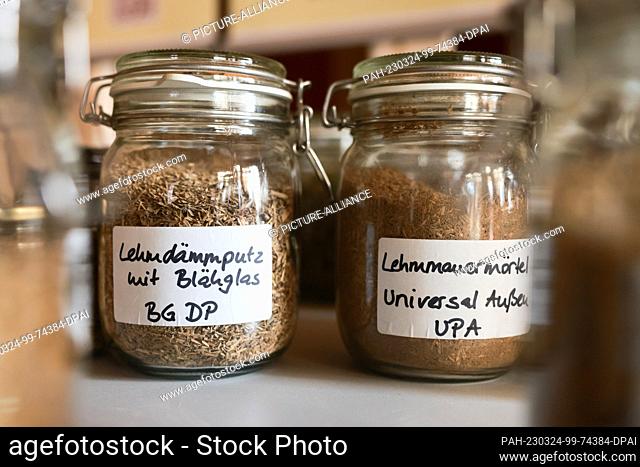 24 March 2023, Thuringia, Gierstädt: Jars with different clay building materials stand on a table in the clay plant. Environment Minister Stengele is here today...