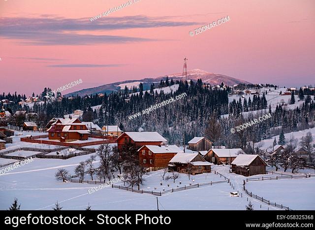 Small and quiet alpine village and winter sunrise snowy mountains around, Voronenko, Carpathian, Ukraine