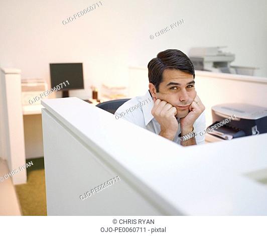 Businessman sitting in office bored and tired