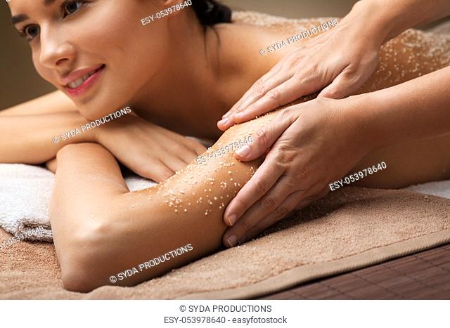 close up of woman having salt massage at spa