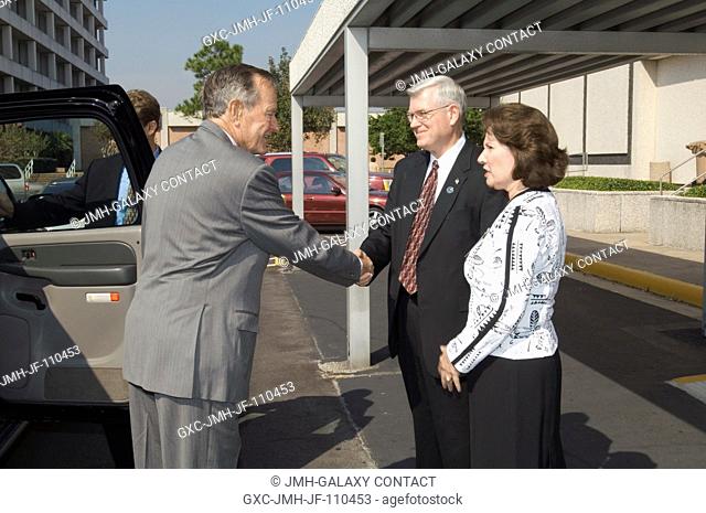 JSC Director Michael L. Coats and Mrs. Coats, greet President George H.W. Bush during his Nov. 1, 2007 visit to Houston and the Johnson Space Center