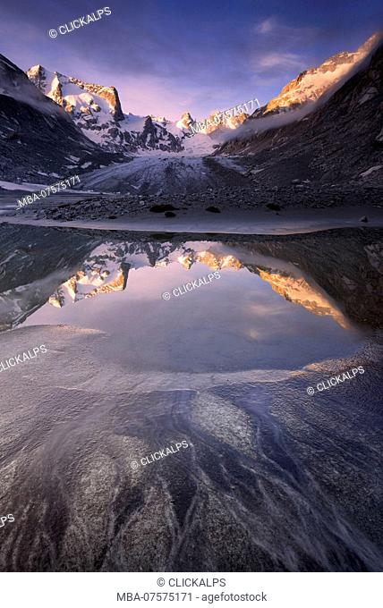 Sunrise from a pond at Forno Glacier, Forno Valley, Maloja Pass, Engadin, Graubünden, Switzerland, Europe