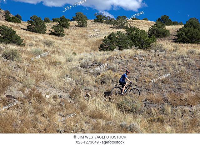 Salida, Colorado - A man rides a bicycle on the Arkansas Hills Trail System, a network of mountain bike trails on land owned by the U S  Bureau of Land...