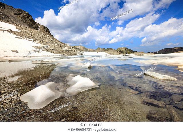 Ice and snow during summer thaw of the alpine lake Joriseen Jörifless Pass canton of Graubünden Engadin Switzerland Europe