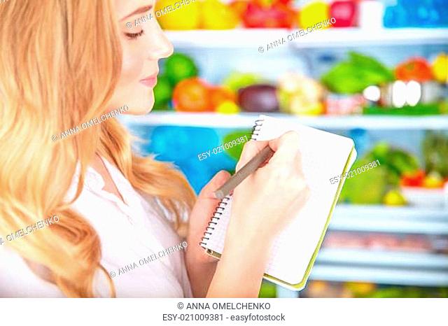 Cute housewife writing list to supermarket