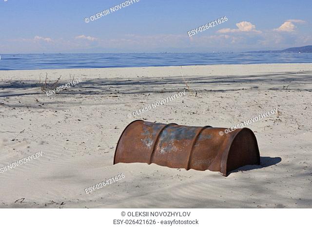Old Rusty Oil Barrel Buried in Sand, End of Oil Age