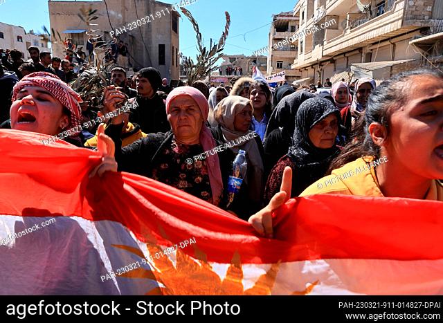 21 March 2023, Syria, Aleppo: Syrian Kurds gather for the funeral of the victims, who were killed by Turkish-backed fighters during the Nowruz celebrations in...