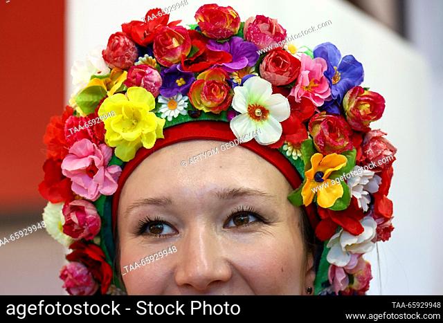 RUSSIA, MOSCOW - DECEMBER 20, 2023: A woman wears a floral wreath at the opening of Zaporozhye Region Day during the Russia Expo international exhibition and...