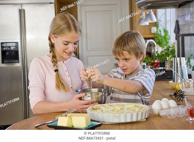 Sister and brother making a cake, Sweden