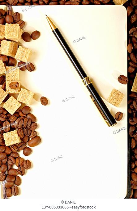 Coffee beans, paper, pen