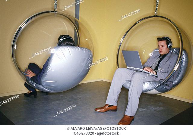 Executives sit in 'Bubble Chairs' (designed by Eero Aarnio, 1968)