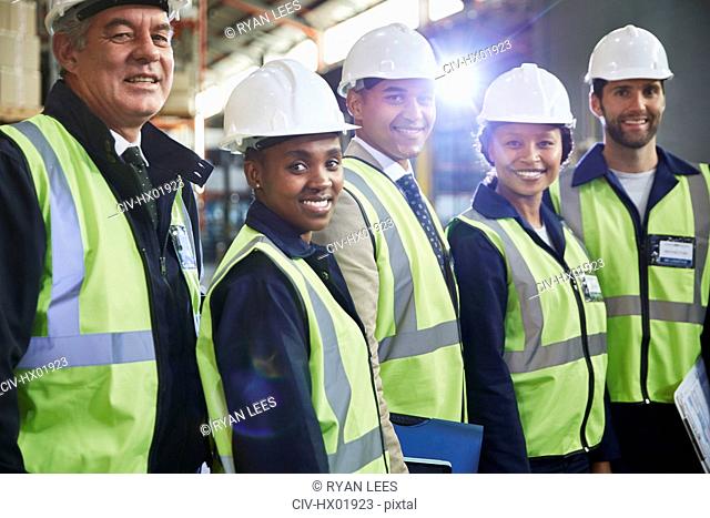 Portrait confident managers and workers in distribution warehouse