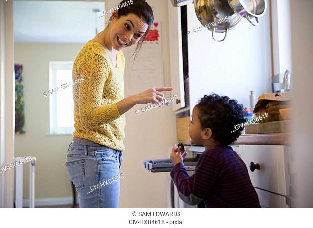 Playful mother and son in kitchen