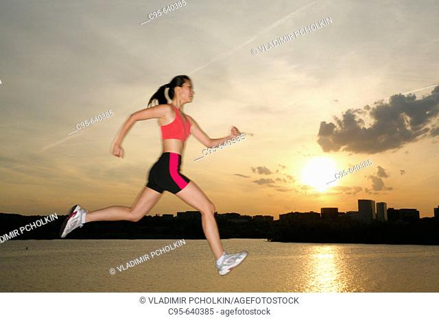 Potomac river, Washington, DC, USA, woman jogging and jumping, 23 years old, Asian