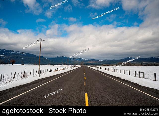 Snow has been cleared from the road on this winter route in the United States