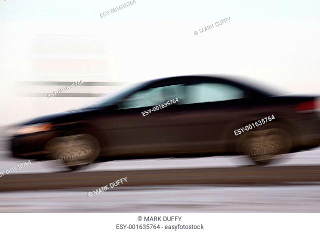 Blurred automobile on highway