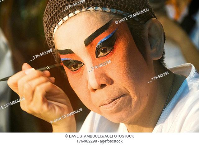 Chinese opera performer gets ready backstage in Bangkok Thailand
