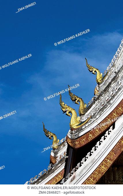 Detail of the multi-tiered roof which is adorned with stylized Naga finials at the roofÂ’s ends on the Haw Pha Bang (the Royal temple) at the Royal Palace...