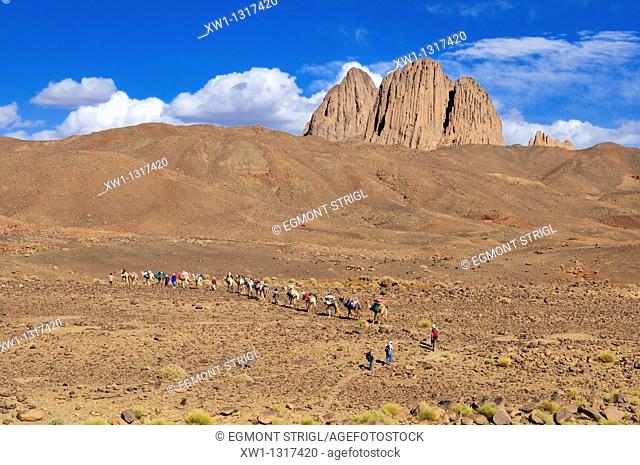 group of tourists hiking through volcanic landscape, Hoggar, Ahaggar Mountains, Wilaya Tamanrasset, Algeria, Sahara, North Africa