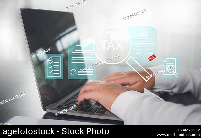 Businesswoman uses computer to fill out online tax return form to pay taxes It represents financial research and tax return calculations