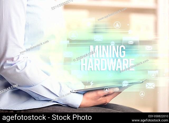 Close-up of a tablet searching MINING HARDWARE inscription, modern technology concept