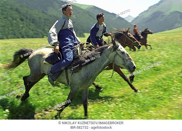 Young horsemen. Akkol Canyon, Kazakhstan