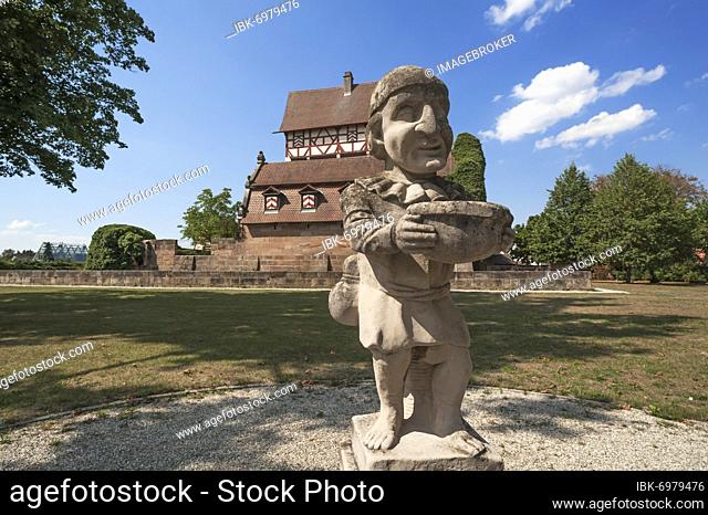 Grotesque gnome of the Baroque in the park, in the back the Neunhofer Jagdschlösschen, 1479, reconstructed in 1964 and 1978/79, Neunhof near Nuremberg