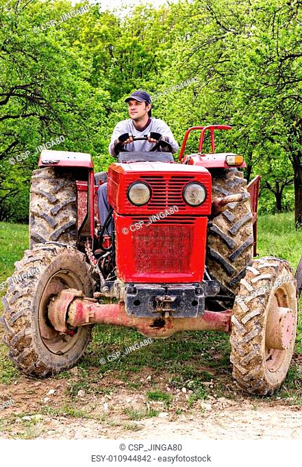 Young farmer driving his tractor