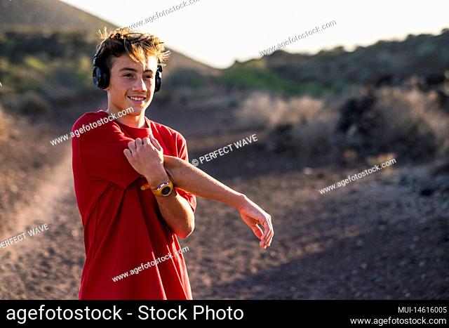 close up of young man doing exercise outdoors and stretching after workout - runner or jogger training to be healthy and fit
