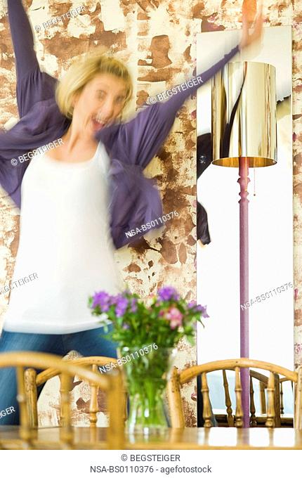 cheering, young woman in living room