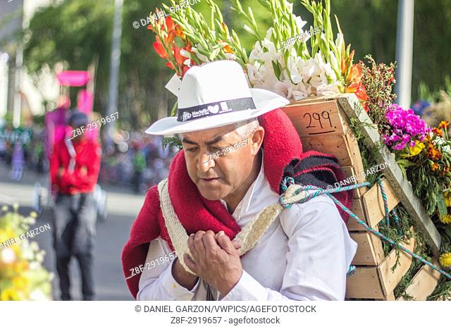 A man carries flowers with the wooden crate in her back during the last day of the Festival of the Flowers in Medellin, Colombia on August 8, 2017