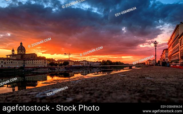 FLORENCE, TUSCANY/ITALY - OCTOBER 19 : View of buildings along the River Arno at dusk in Florence on October 19, 2019. Unidentified people