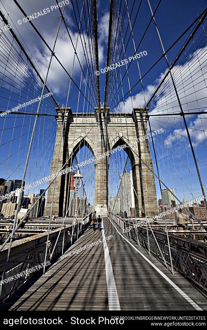 Pedestrians walking on the Brooklyn Bridge. It is one of the oldest bridges in the United States, which Manhattan and Brooklyn by spanning the East River