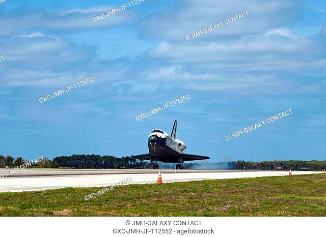 Space shuttle Discovery's main gear touches down on Runway 15 at the Shuttle Landing Facility at NASA's Kennedy Space Center in Florida