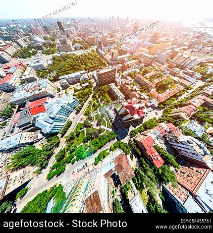 Aerial city view with crossroads, roads, houses, buildings, parks and parking lots. Copter drone helicopter shot. Panoramic wide angle image