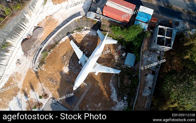 Aerial top drone view of abandoned airplane, old crashed aircraft wreck tourist attraction located in South Kuta, Bali, Indonesia