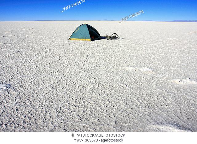 A tent and a bicycle on the frozen salt lake called 'Salar de Uyuni' in Bolivia
