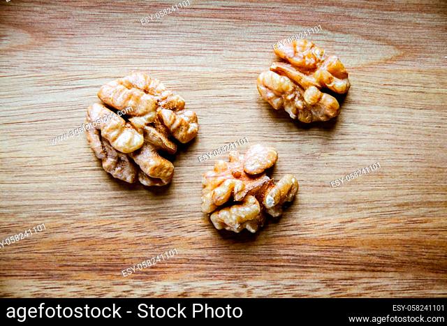 Walnut kernels on a wooden cutting board. Top view