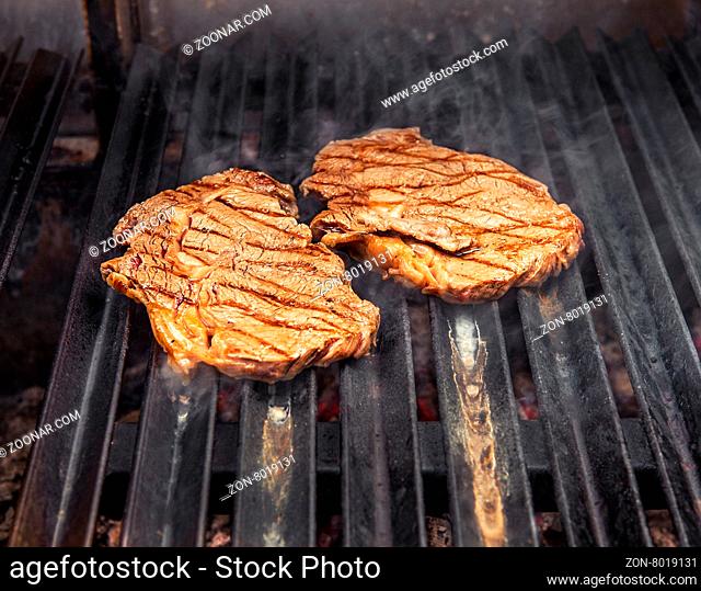 Delicious beef steak, hot barbecue grill