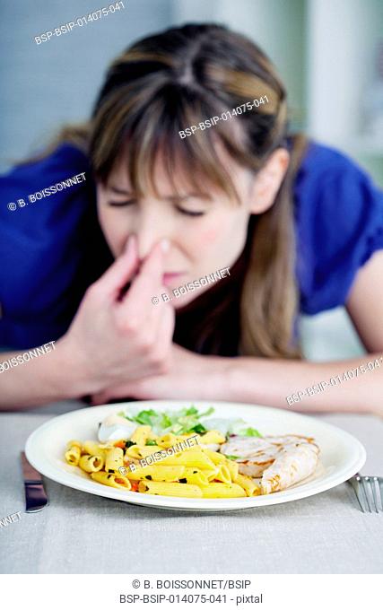 Woman smelling her meal