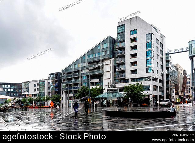 Oslo, Norway - August 10, 2019: New residential luxury buildings in Aker Brygge area a rainy day of summer. It is a popular area for shopping