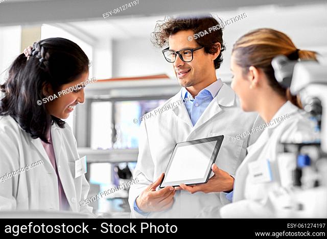 scientists with tablet pc working in laboratory