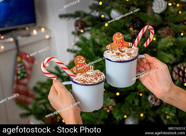 Christmas, mugs of egg nog with whipped cream and candy canes