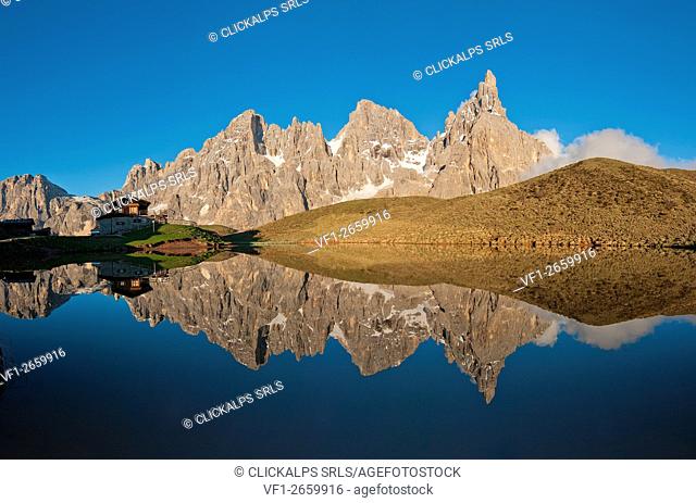 Passo Rolle, Dolomites, Trentino, Italy. The mountaingroup of Pala di San Martino reflecting in the lake near Segantini Hut